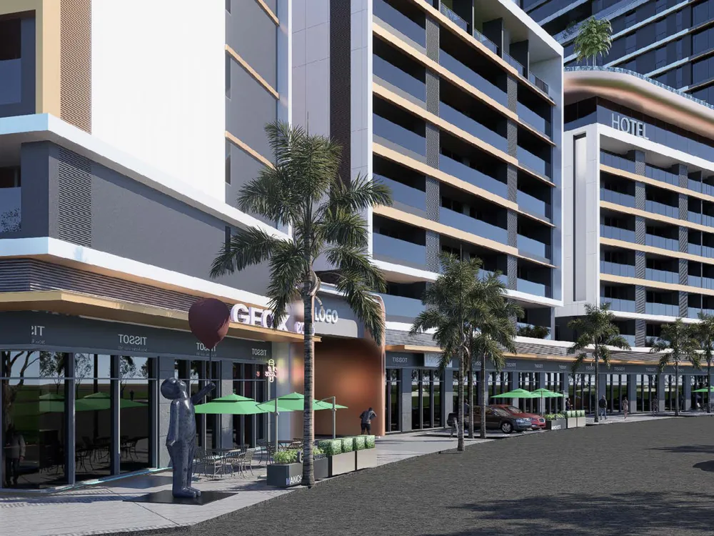 Ground-floor retail frontage with shaded terraces along the internal street