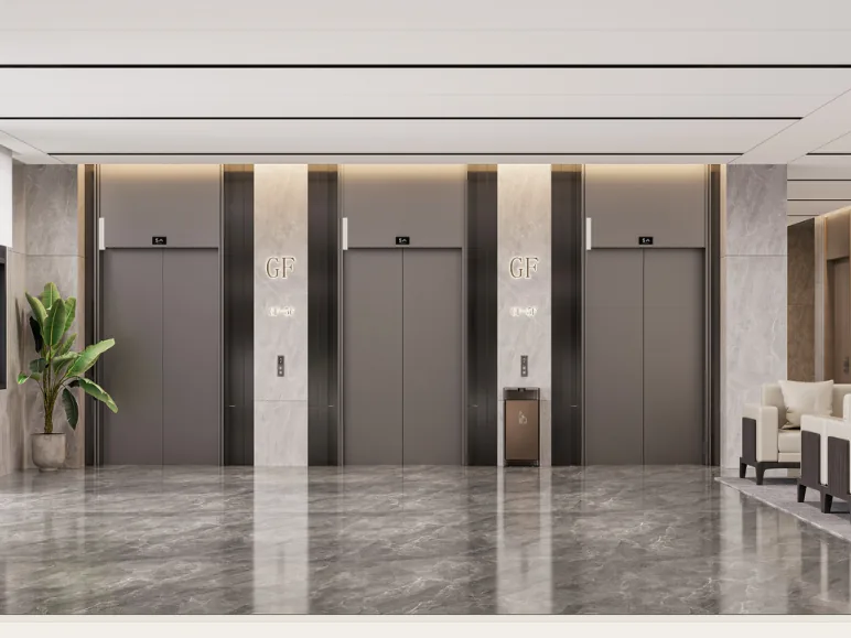 Ground-floor lift lobby with stone walls, concealed lighting and a lounge seating area