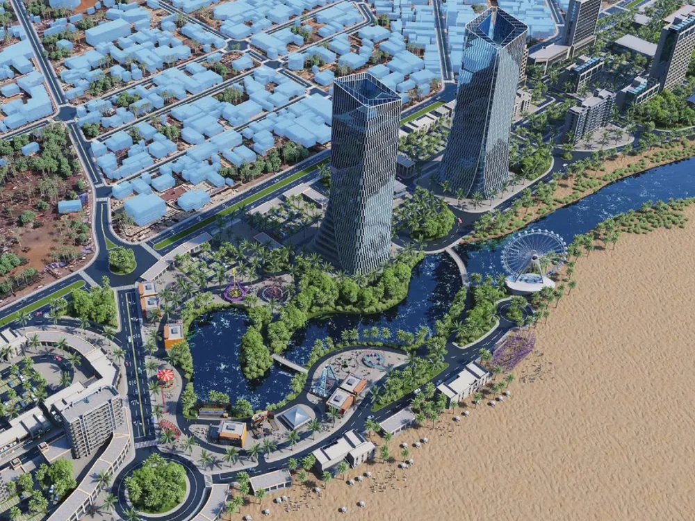 Aerial view of a coastal district with twin towers and a waterfront park