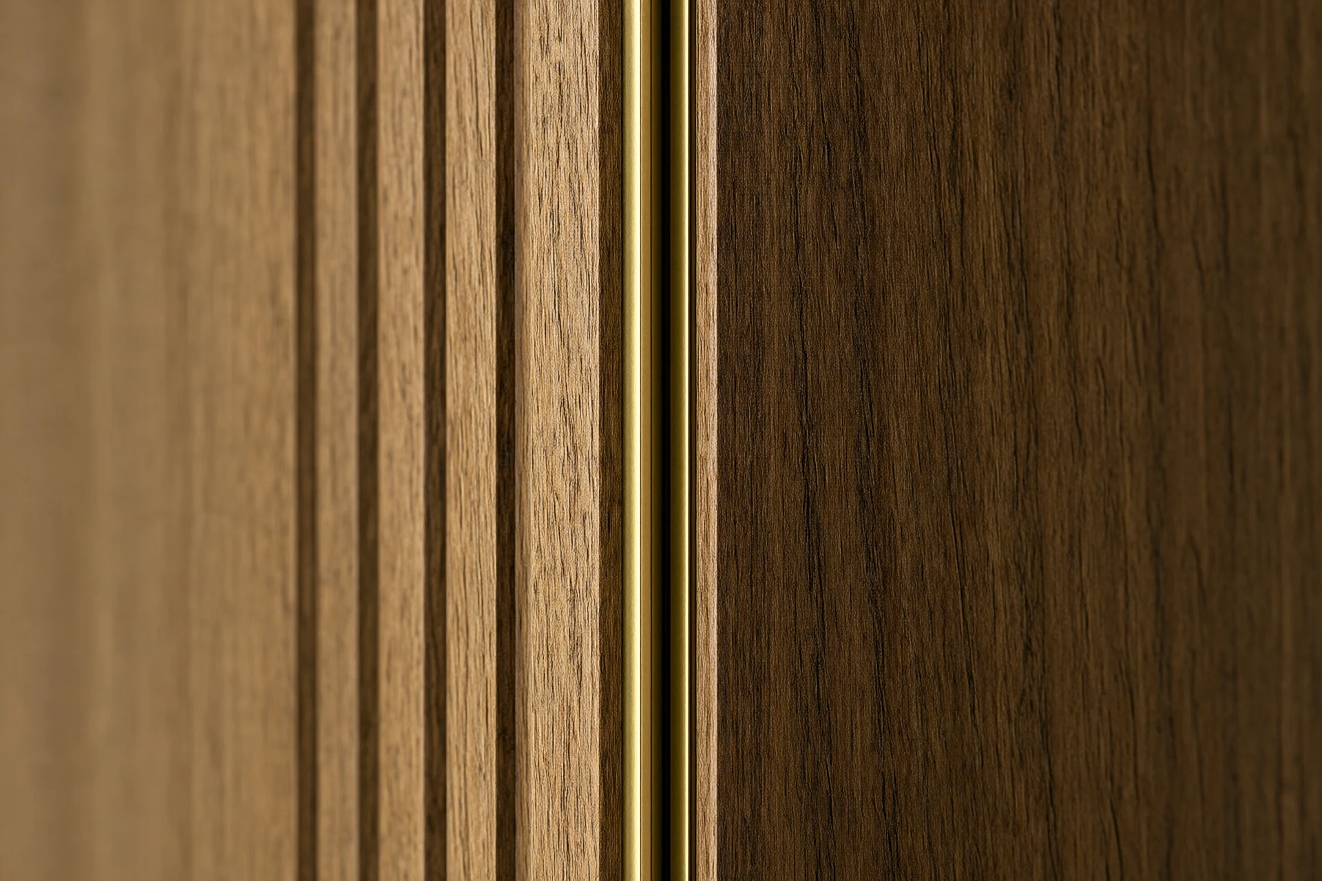 Macro detail of walnut veneer grain with a brass reveal channel and shadow gap