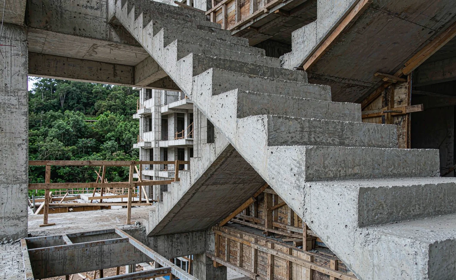 Cast in-situ concrete staircase under construction with timber formwork on a mid-rise building site
