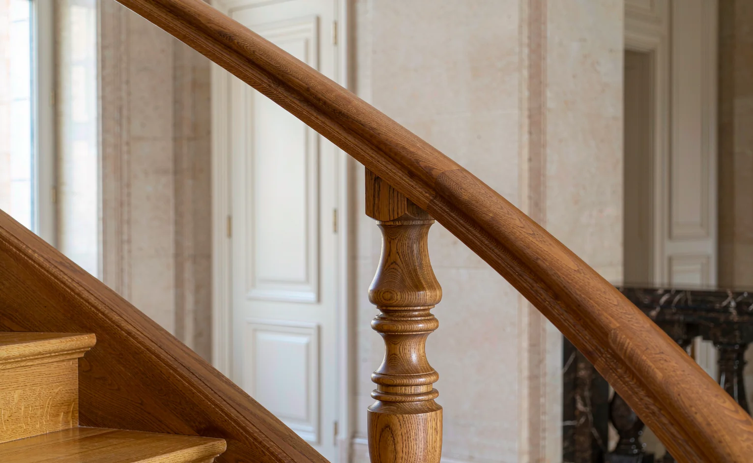Engineered hardwood stair treads and turned wooden handrail detail in a villa interior