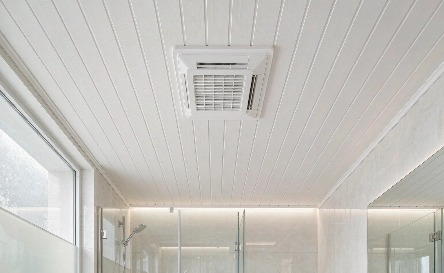 White PVC tongue-and-groove ceiling panels with an extractor vent in a humid tropical bathroom