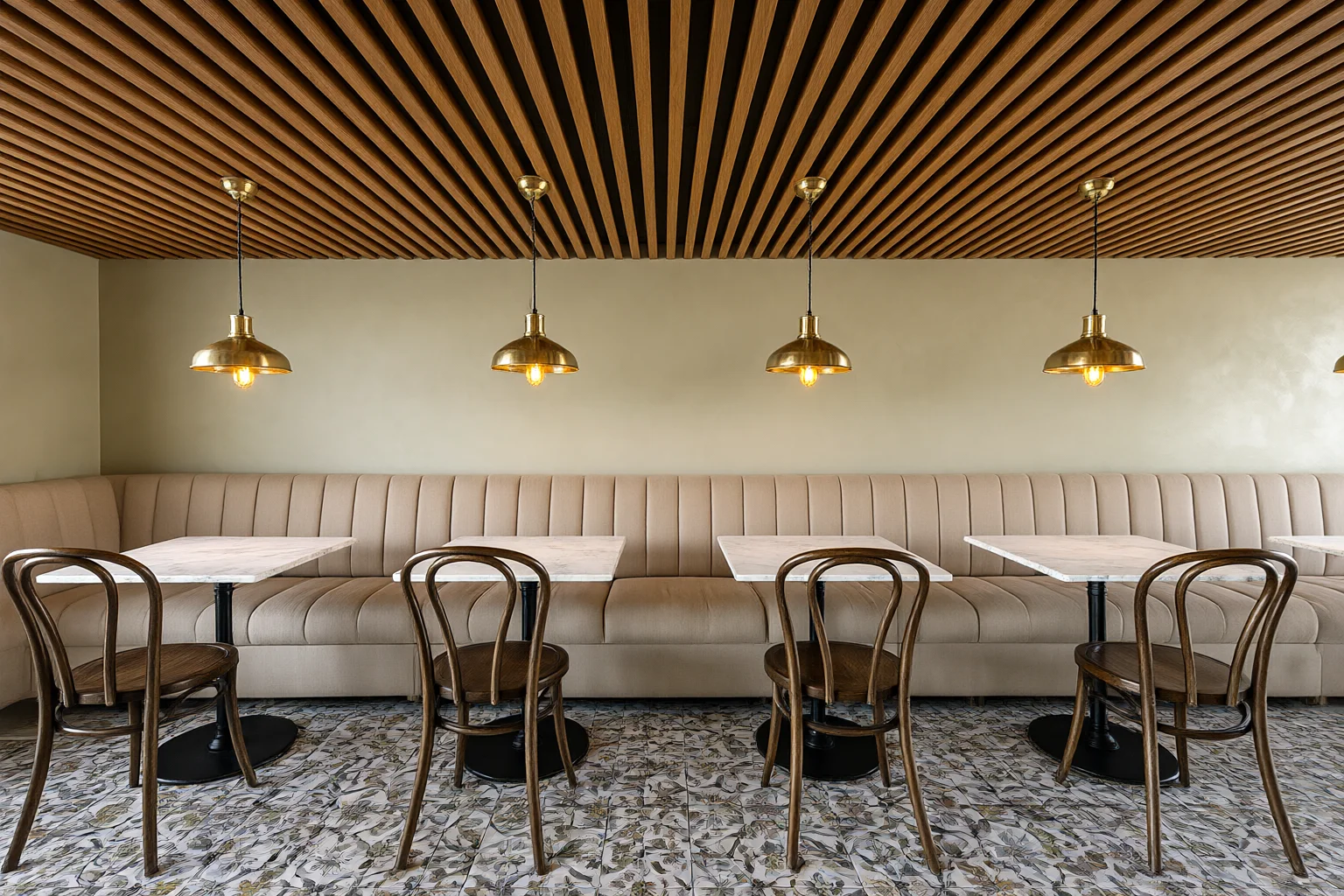 Restaurant dining room with timber slatted ceiling, brass pendant lights, upholstered banquette and patterned tile floor