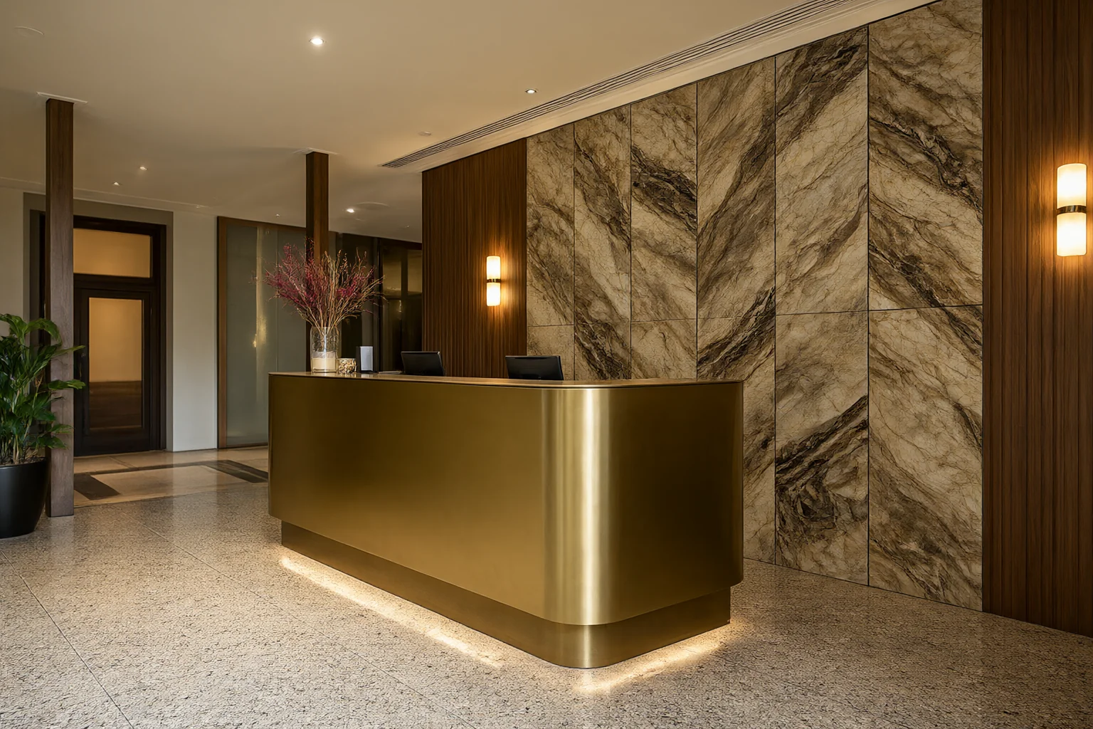 Commercial interior design ideas: hotel lobby reception desk in brushed brass with bookmatched stone feature wall and terrazzo floor