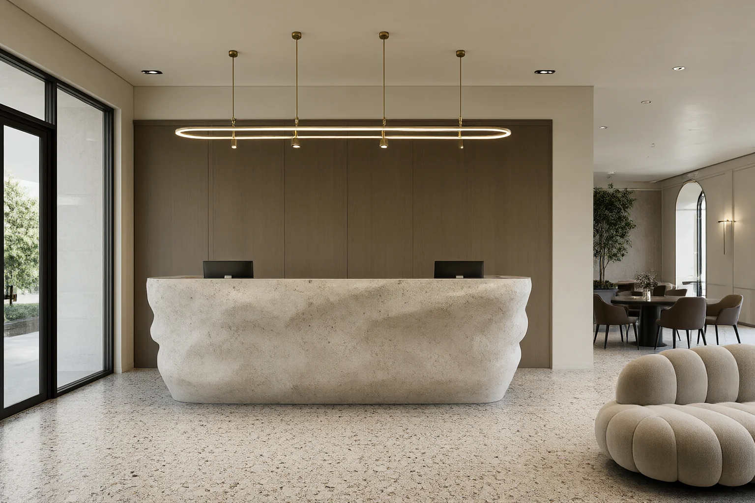 Commercial modern interior design hotel lobby with terrazzo floor, sculptural stone reception counter, linear brass pendants and curved sofa