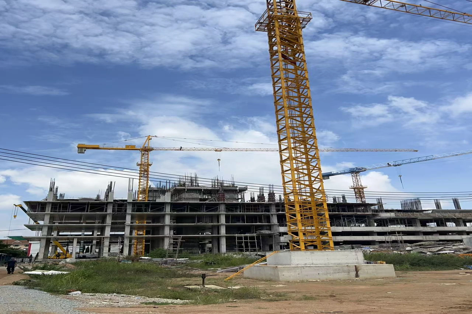 Mixed-use development construction site in Thailand with tower cranes and in-situ concrete frame