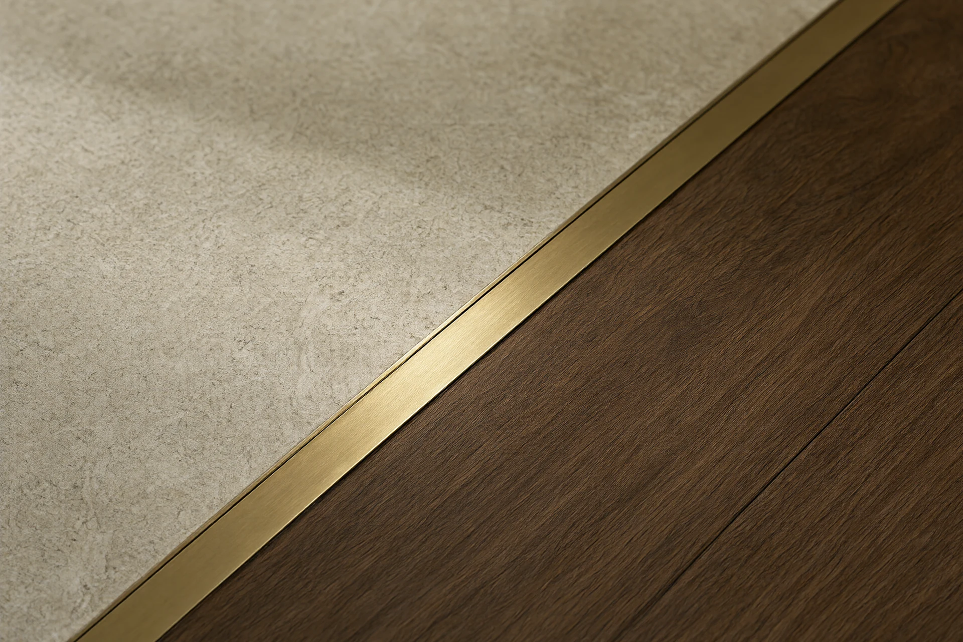 Close up of a stone threshold meeting walnut flooring with a brass transition strip